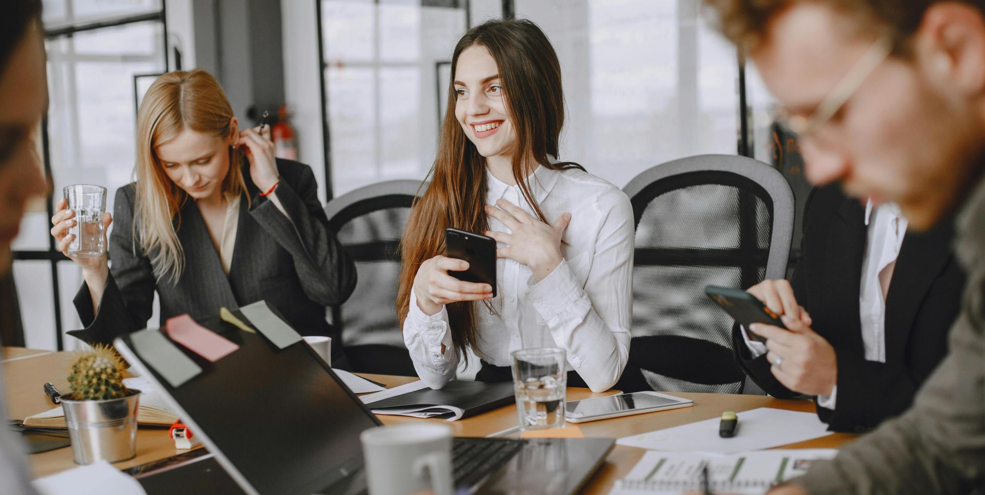 Business professionals engaging in a dynamic team meeting with modern technology.